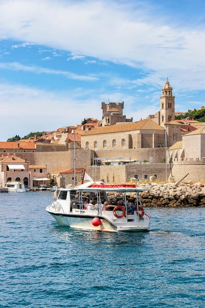 Motor boat at the Old port in the Adriatic Sea of Dubrovnik, Croatia. People on the background