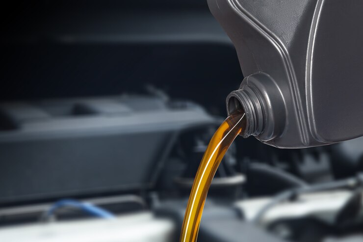 Photo motor oil pouring, pouring oil lubricant motor car from bottle 