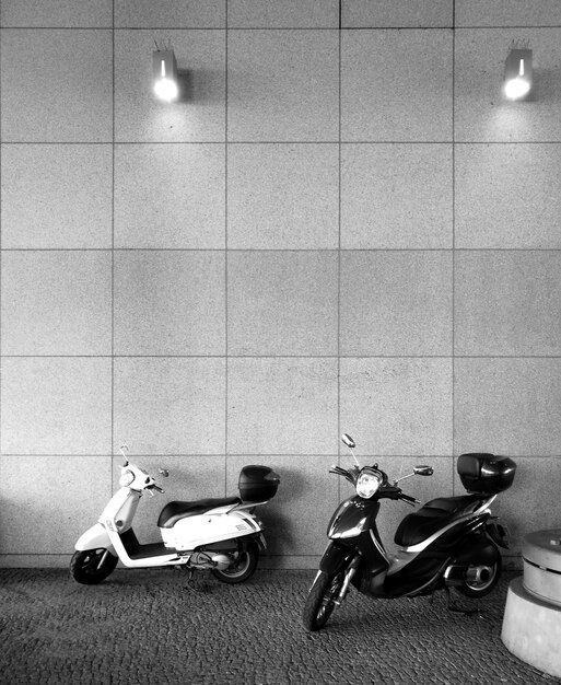 Photo motor scooter parked against wall