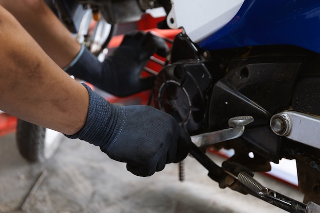 Motor style. mechanic fixing motorcycle with soft-focus and over light