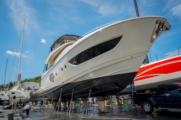 Motor yacht moored for repairs and service in dry dock