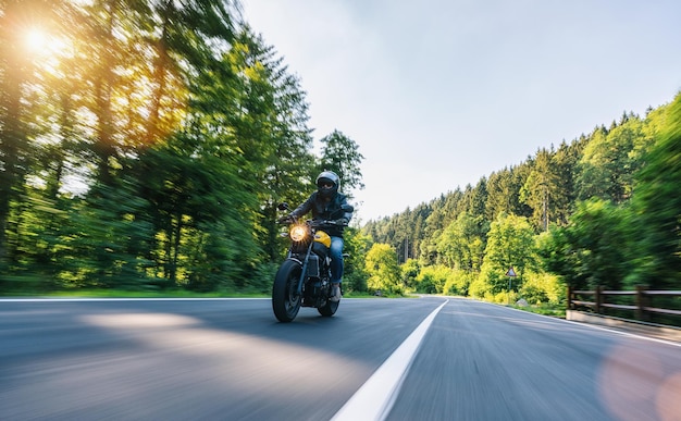 Motorbike on the Alpine highway riding having fun driving the empty road on a motorcycle tour journey copyspace for your individual text