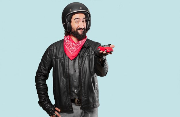 Motorbike rider holding a red car model