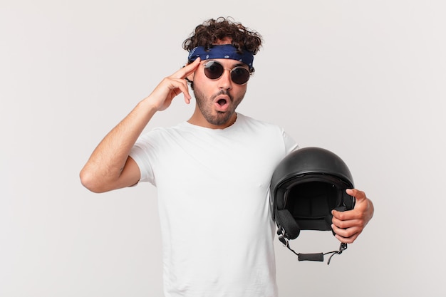 Motorbike rider looking surprised, open-mouthed, shocked, realizing a new thought, idea or concept