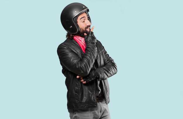 Motorbike rider thinking  or doubting