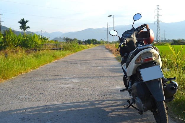 A motorbike on the road among rice fields in Vietnam