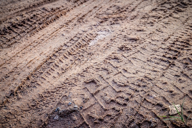 motorcycle and car tire track print on sand or mud with selective focus