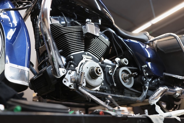 Motorcycle engine on stand in car workshop motorcycle maintenance concept