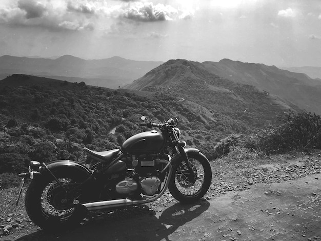 Motorcycle on mountain against sky