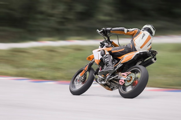 Motorcycle practice leaning into a fast corner on track