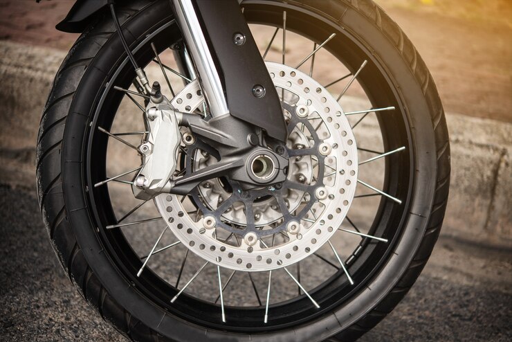 Motorcycle wheel in black and white with ABS brakes.
