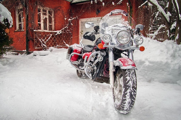 Motorcycle in the winter parking lot at the house