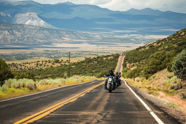 Photo a motorcyclist rides down the road in the mountains