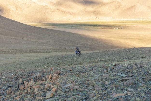 Un motociclista prova la sua moto sulle colline della mongolia