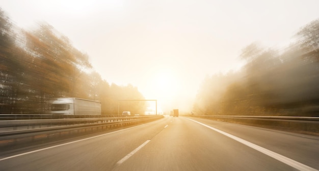 motorway, with limited traffic, on a foggy autumn day, copyspace for your individual text.