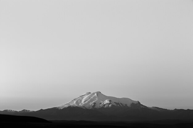 Mount Elbrus at dawn. View of the sunlit slopes of the volcano from the northwest. The North Caucasus in Russia.