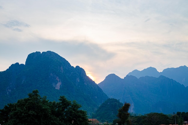 Mountain as the sun sets Mountain peak green nature scenery Beautiful sunset over the mountain range at vang vieng