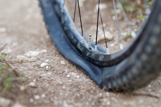 Mountain bike got Flat bike tire on trail. Selective focus.
