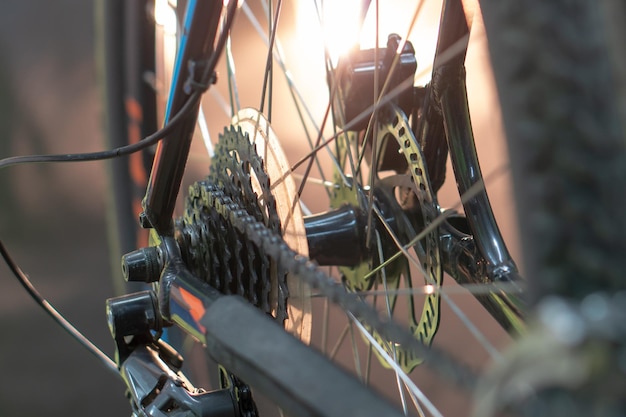 Mountain bike repair Various parts of a modern bicycle closeup A rear wheel a rusty chain and a dirty tire on the bike