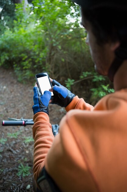 Mountain biker using mobile phone