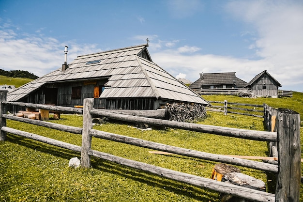 Mountain cottage hut or house on hill Velika Planina alpine meadow landscape Eco farming Travel destination for family hiking Kamnik Alps Slovenia Big Plateau