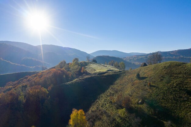 Mountain countryside homestead in the autumn Wooden barns aerial drone view Transylvania Romania