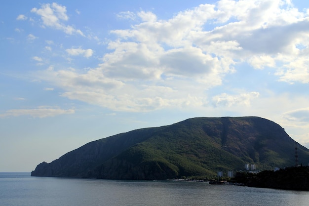 Mountain in Crimea in form of a bear. Clouds in the sky. Coastline.