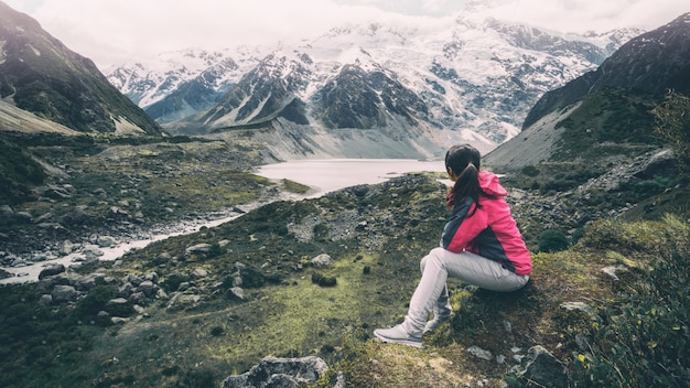 Mountain hiker traveling in wilderness landscape.