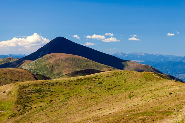 Mountain Hoverla in Carpathians, Ukraine. Beautiful mountain view in summer with green meadow and blue sky.