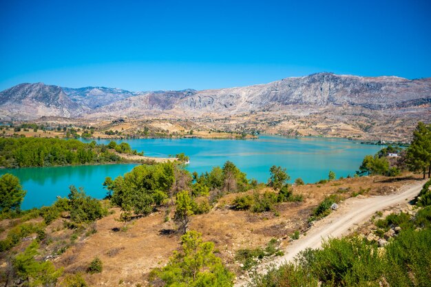 Mountain lake emerald water reservoir behind the dam oymapinar green canyon in manavgat region turkey high quality photo