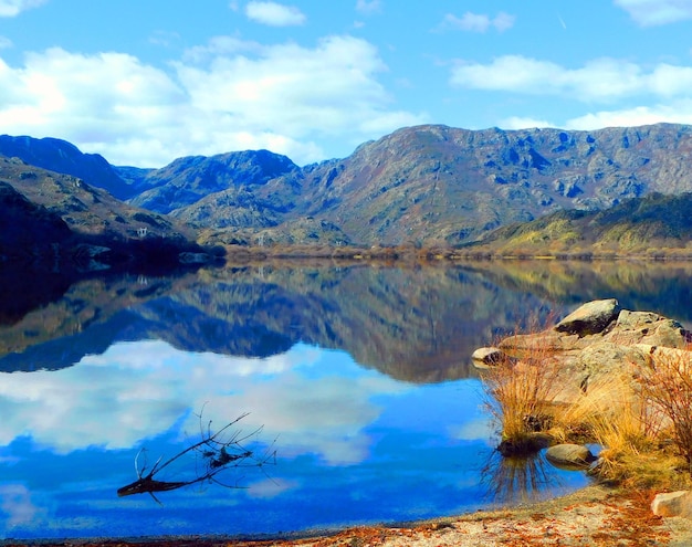 A mountain lake with a reflection of the mountains in it.