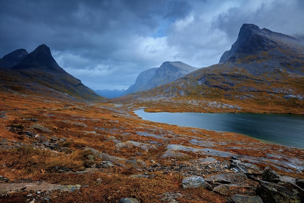 Mountain landscape in evening Rocky shore of mountain lake in rainy autumn Beautiful nature Norway
