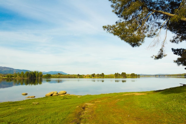 Mountain landscape reflected in the water of a lake on a sunny day Copy space Selective focus