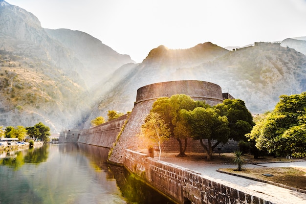 Mountain landscape with the fortress of the old town of Kotor at dawn in Montenegro