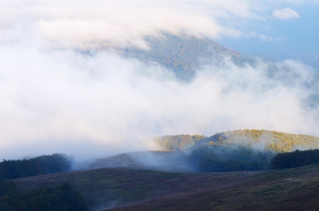 Mountain landscape with low clouds. Fog over the hills