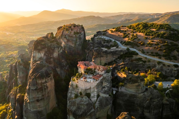 Mountain monastery and rocks in Meteora at sunset Greece