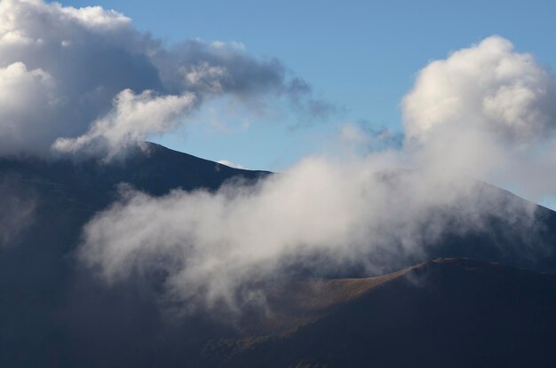 Mountain peaks in cumulus clouds. Carpathians, Ukraine, Europe