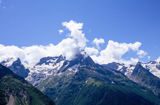 Mountain peaks with snow lying in the summer. Dombay, July 2021