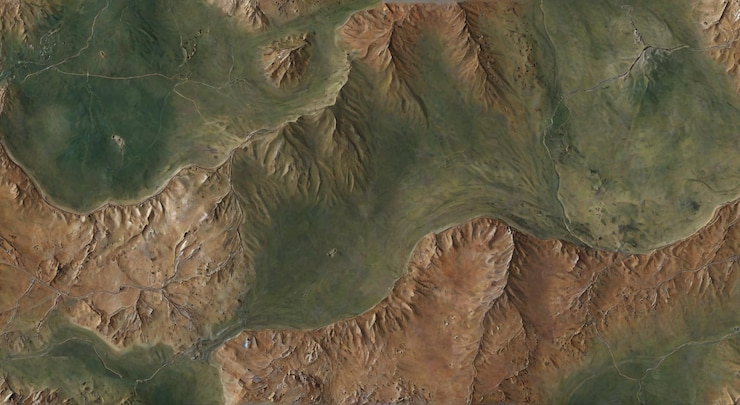 Photo a mountain range is seen from the sky