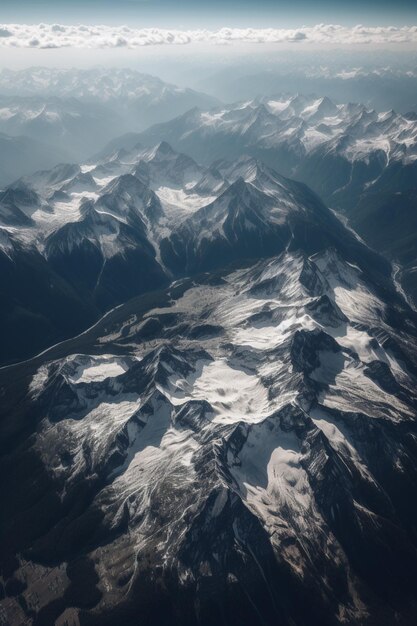 A mountain range is seen from above with the sun shining on it.