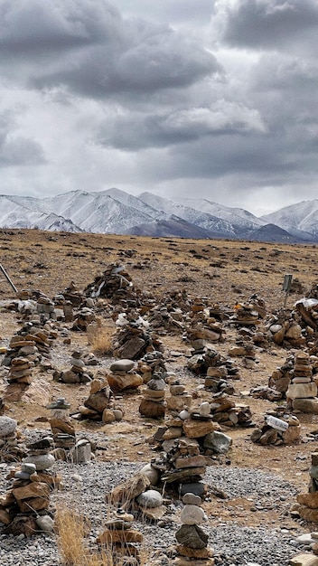 A mountain range is seen behind a pile of rocks.