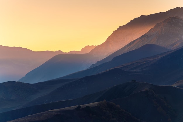 Mountain range at sunset. North Caucasus, Russia. Blue mountains and the pink sky. Beautiful autumn landscape