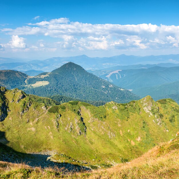 Mountain range with dry yellow grass and blue sky