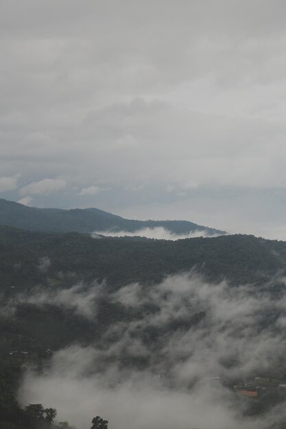 Mountain range with visible silhouettes through the morning blue fog