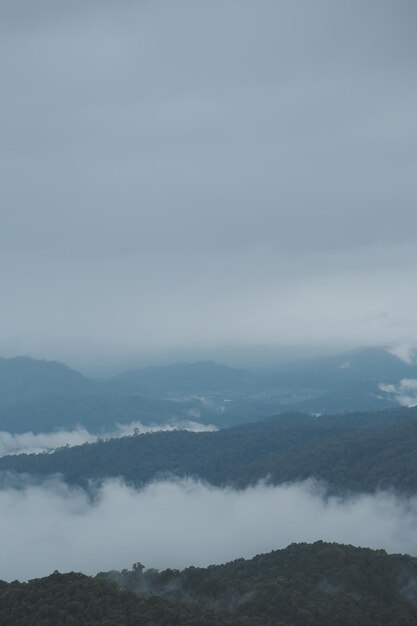 Mountain range with visible silhouettes through the morning blue fog