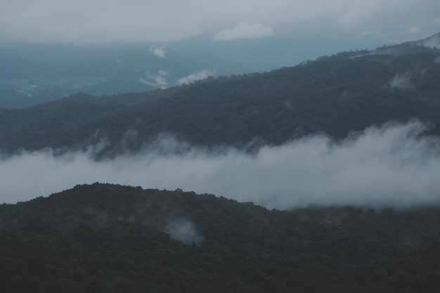 Mountain range with visible silhouettes through the morning blue fog