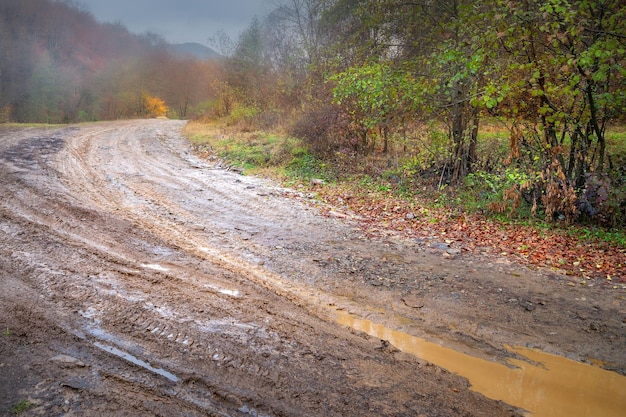 Mountain road Dirty wet road during rains in the mountains