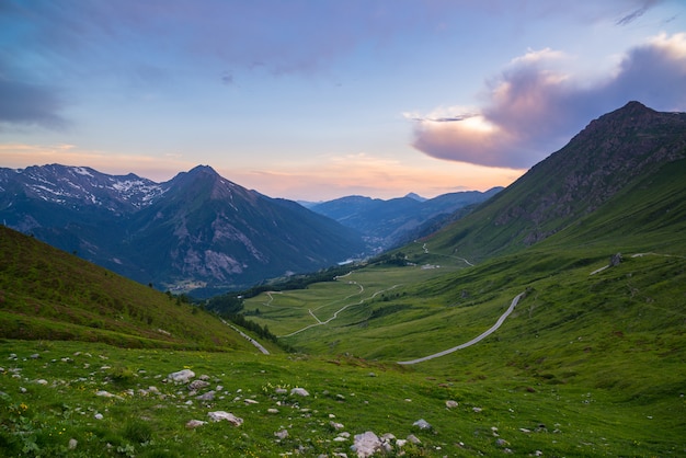 Mountain road leading to high mountain pass on the Italian Alps.