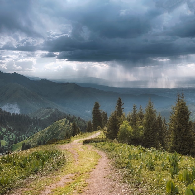 Mountain road on the ridge and rain over the city Almaty