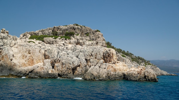 Mountain of rocks in the foreground over the sea